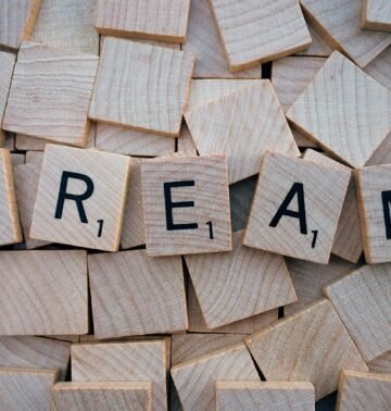Close-up of wooden Scrabble tiles spelling the word 'DREAM', symbolizing creativity and imagination.